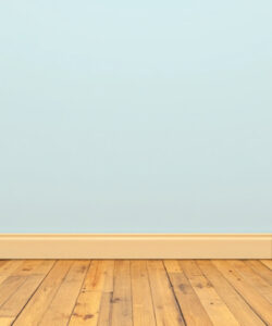 A-minimalist-room-with-a-light-blue-wall-wooden-floor-and-beige-baseboard-photographed-in-a-clean-simple-style