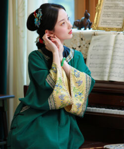 A photograph of an asian woman with a delicate face in a green traditional dress playing a piano