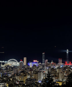A-vibrant-night-photograph-of-San-Francisco-featuring-illuminated-skyscrapers-the-Bay-Bridge-and-the-iconic-Golden-Gate-Bridge