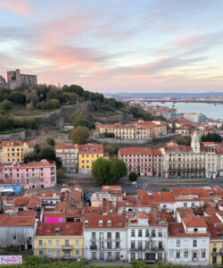 Aerial-photograph-of-Porto-Portugal-at-sunset-featuring-colorful-buildings-the-Dom-Luis-Bridge-and-the-Douro-River