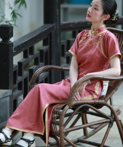 Asian woman sitting on a wicker chair wearing a red qipao medium shot jpeg artifacts