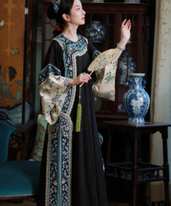 Elegant asian woman in traditional black and blue floral dress ornate blue vase vintage room photograph