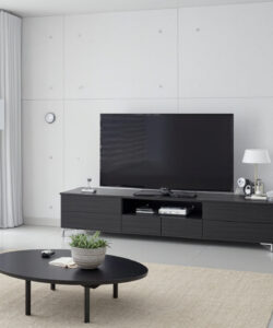 Modern-minimalist-living-room-with-white-walls-large-flat-screen-TV-sleek-black-entertainment-center-beige-sofa-and-potted-plant