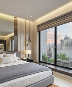 Modern-spacious-bedroom-with-a-large-bed-floor-to-ceiling-windows-and-a-cityscape-view-at-sunset