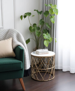 Photograph-Green-velvet-armchair-with-beige-pillow-white-framed-window-grey-curtains-potted-plant-round-gold-side-table-dark-wooden-floor