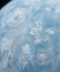 Photograph-of-Earth-from-space-showing-two-swirling-storm-clouds-over-the-blue-oceans-and-white-cloud-formations