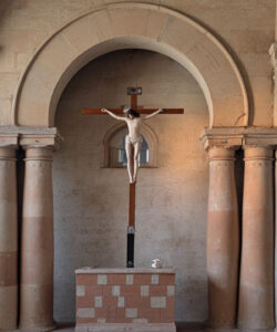 Photograph-of-a-church-altar-featuring-a-crucifix-marble-columns-and-statues-with-a-serene-sacred-atmosphere