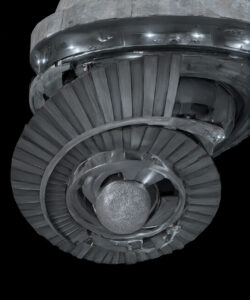 Photograph-of-a-metallic-spherical-UFO-with-a-circular-ridged-opening-set-against-a-stark-black-background