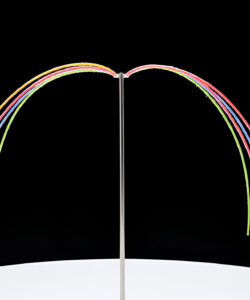 Photograph-of-a-modern-abstract-sculpture-with-curved-colorful-neon-lights-on-a-black-background-and-white-circular-base