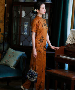 Photograph of a slender asian woman in a mustard orange cheongsam standing beside a piano in a vintage dimly lit room