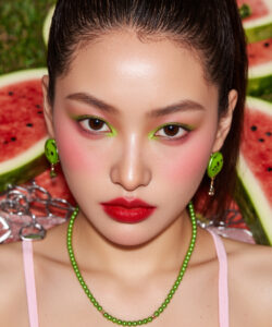 Asian Woman With High Cheekbones Green And And Red Eyeshadow Red Lips Green Earrings