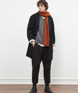 Cozy Winter Style Curly Haired Man In Black Coat Orange Scarf