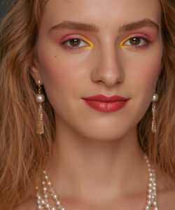 A Fair Skinned Woman With Wavy Blonde Hair Wearing Pearl Earrings And Necklaces Vivid