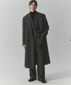 Curly Hair Wearing A Dark Pinstriped Double Breasted Overcoat And Matching Suit