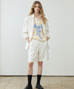 Fair Skinned Blonde Woman In White Linen Suit Floral Sweater Knee High Socks Black