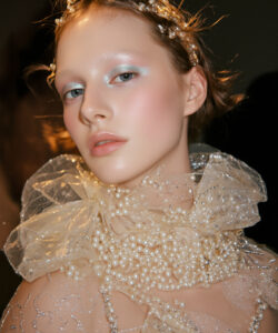 Fair Skinned Woman With Blue Eyes Adorned Adorned In Glittering Pearls And A Delicate