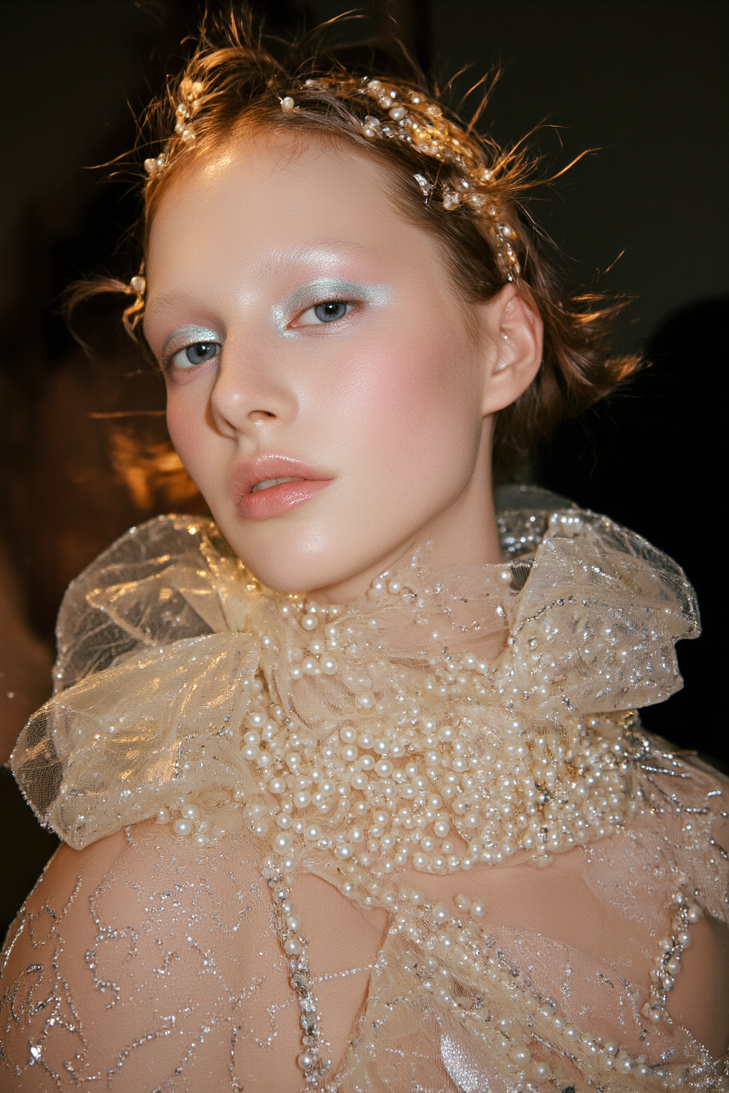 Fair Skinned Woman With Blue Eyes Adorned Adorned In Glittering Pearls And A Delicate