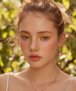 Fair Skinned Woman With Green Eyes Wearing Wearing A Heart Shaped Necklace In A