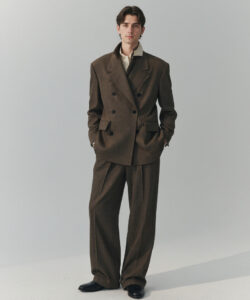 Fair Skinned Young Man With Brown Hair Wearing A Double Breasted Brown Suit And