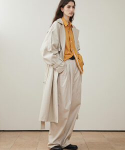 Long Haired Woman In Oversized Beige Beige Trench Coat Mustard Shirt Loose
