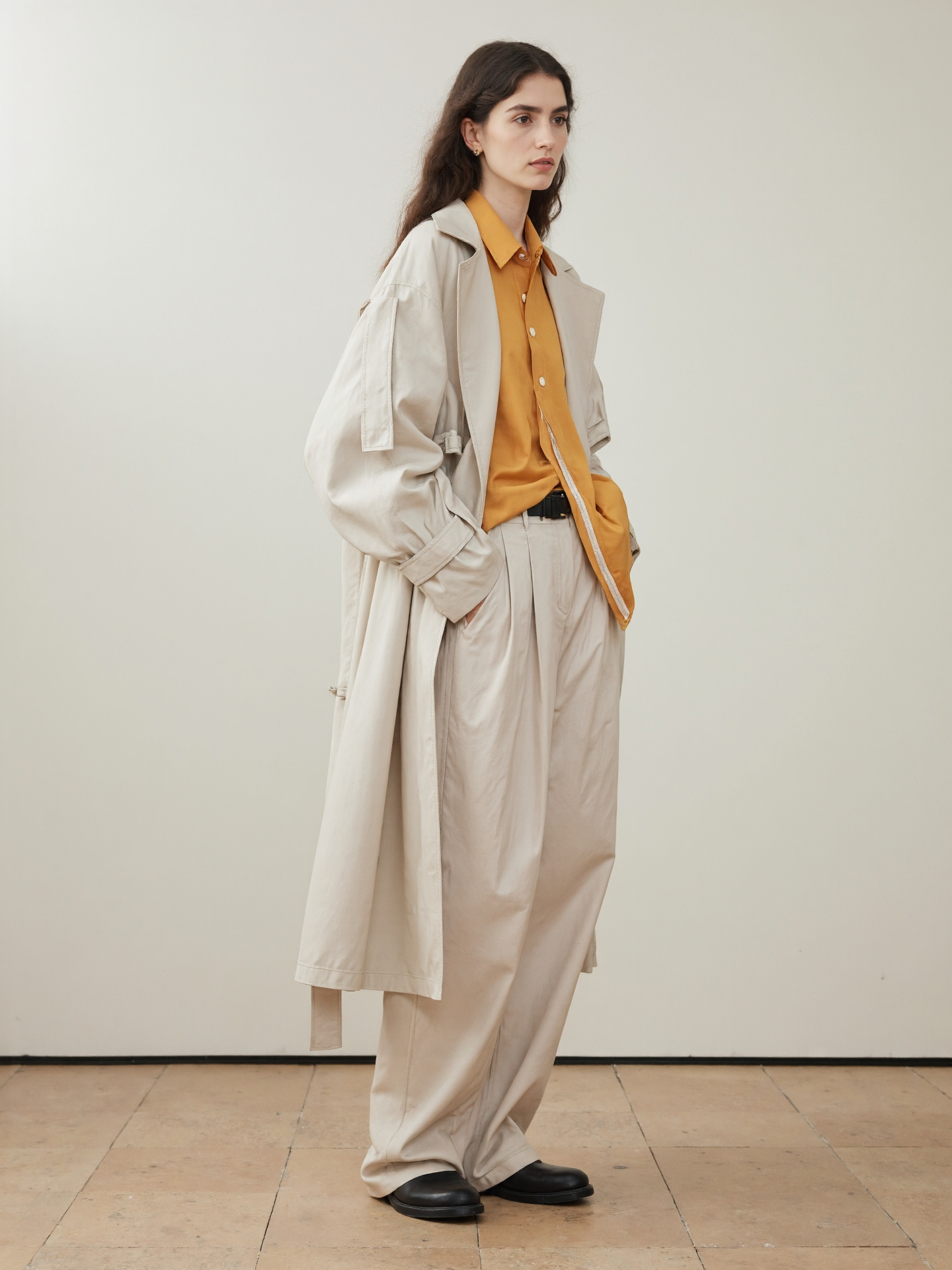 Long Haired Woman In Oversized Beige Beige Trench Coat Mustard Shirt Loose