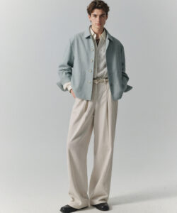 Of A Young Man In A Light Blue Shirt Shirt Beige Pants And A Matching Blazer Hands In