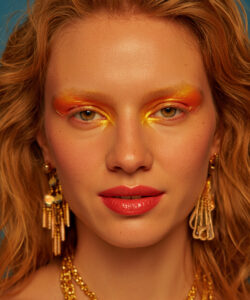 Skinned Blonde Woman With Vibrant Orange And And Yellow Eye Makeup Red Lipstick Gold 1