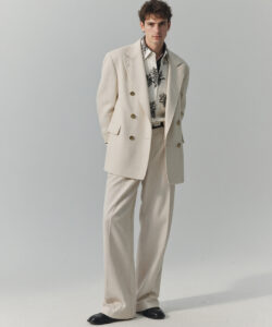 Skinned Man In A Cream Double Breasted Breasted Suit Black Shoes And Patterned Shirt