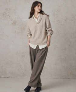 Young Woman In A Beige Knit Sweater Sweater White Shirt Loose Brown Trousers Black